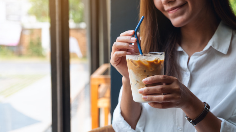 Woman drinking banana coffee 