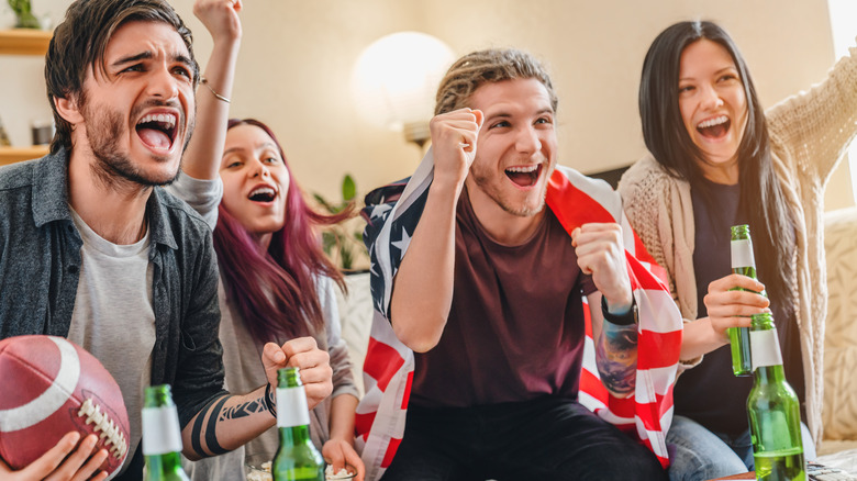 Fans cheering at Super Bowl party