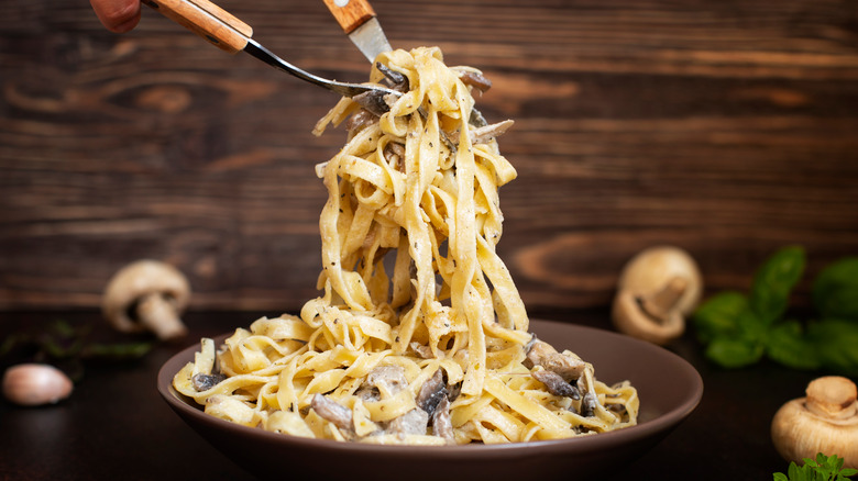 Serving creamy mushroom pasta