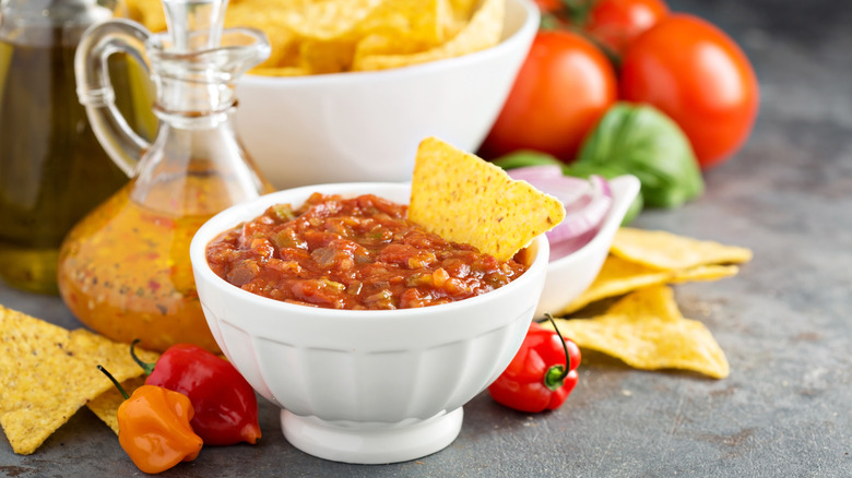 homemade salsa in a white bowl with peppers and tomatoes