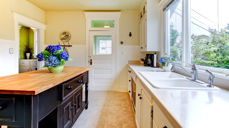 Antique island with dark finish in kitchen