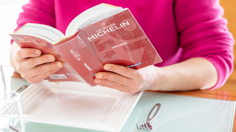diner reading Michelin France guide