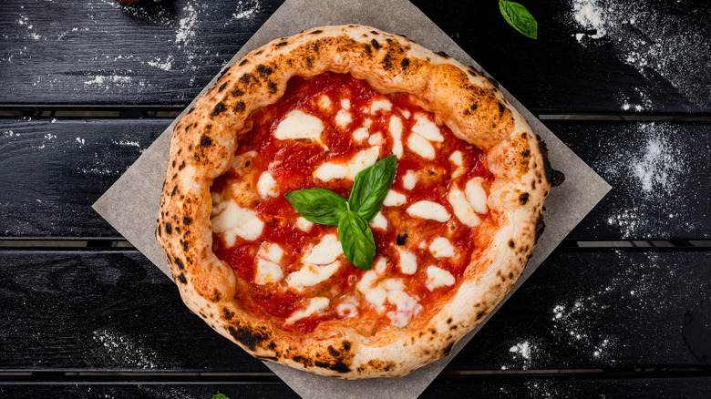 margarita pizza on black wood