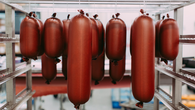 Packed bologna hanging on kitchen rack