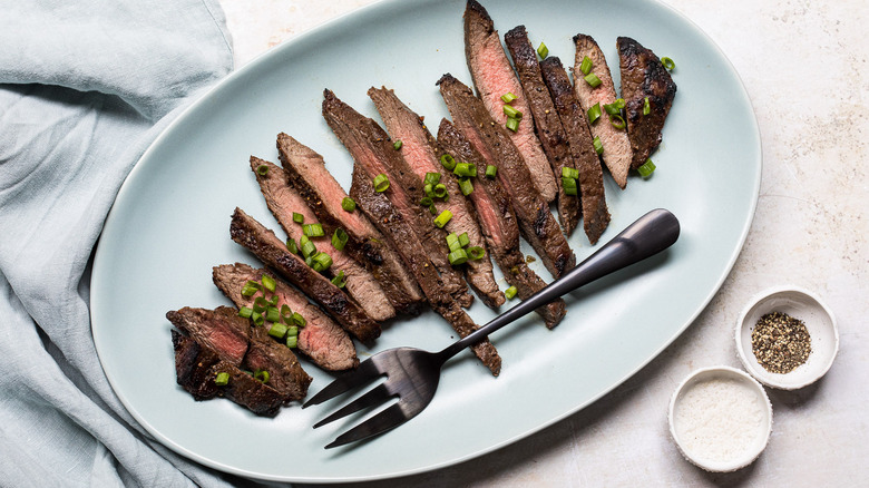 sliced steak on white plate