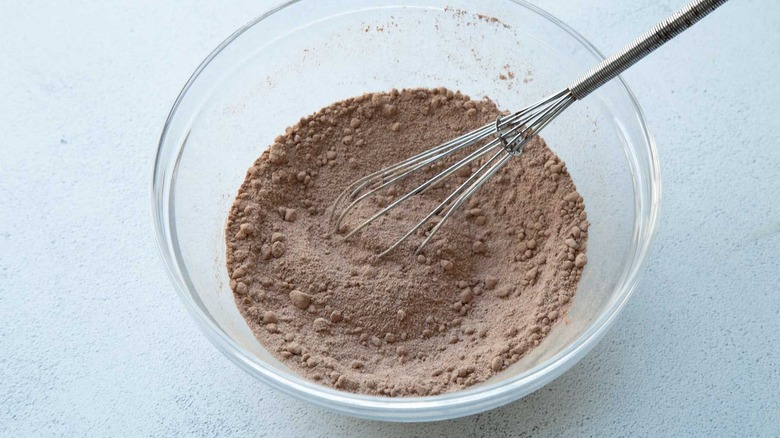 Cocoa powder mixture in bowl with whisk