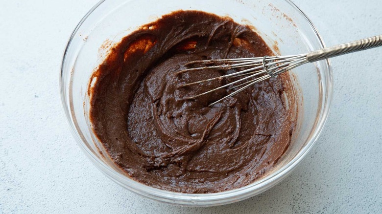 Brownie batter in bowl with whisk