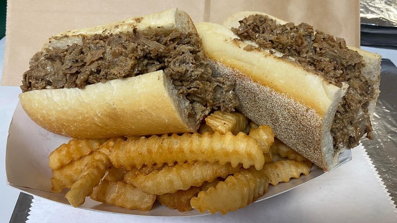 A Philly cheesesteak sandwich with fries at the Roman Pantry