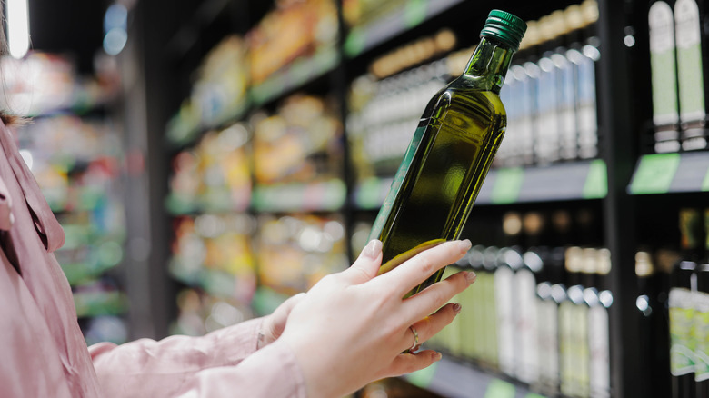 person shopping for olive oil