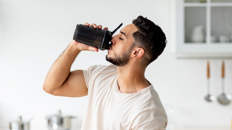 man drinking from bottle