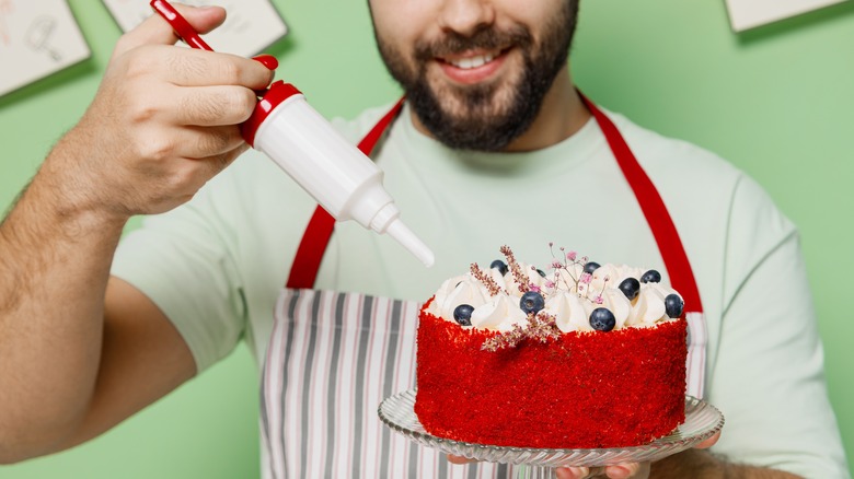 Person decorating cake