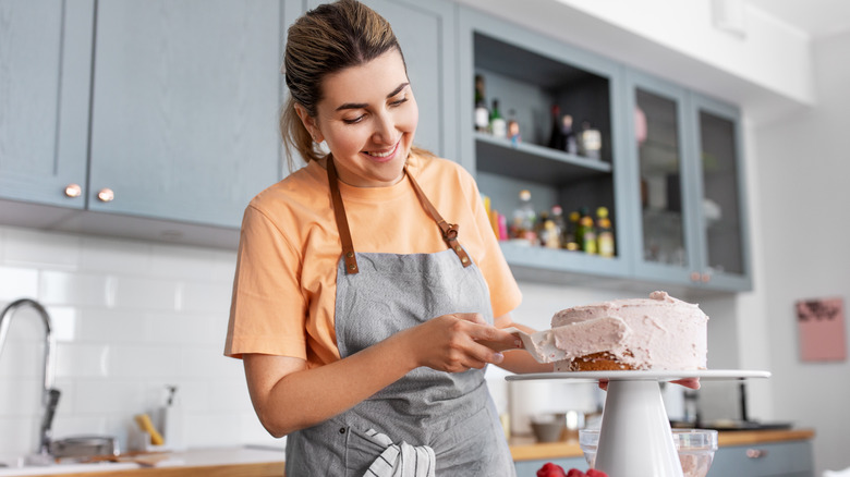 Person frosting cake