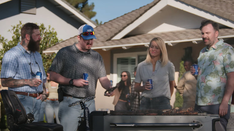Post Malone, Shane Gillis and neighbors standing over grill with Bud Light