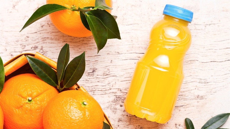Bottle of orange juice with oranges