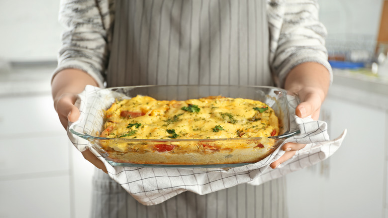 Person holding casserole made in Pyrex dish