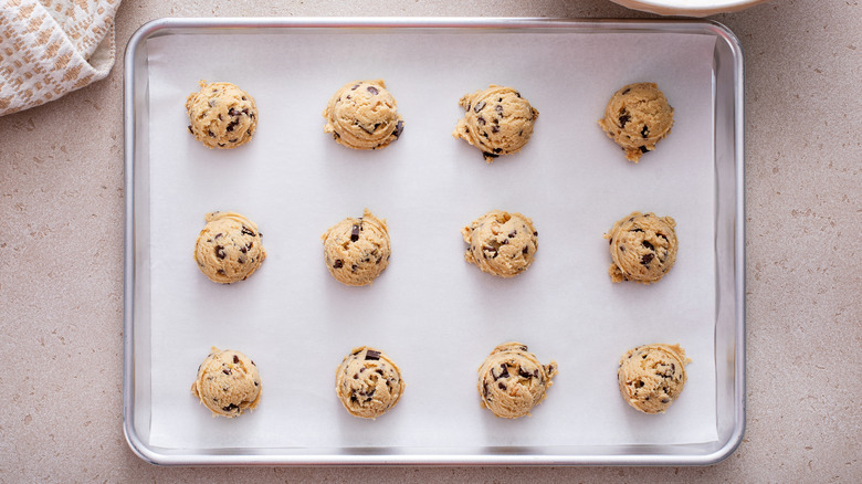 Cookie dough balls ready to bake on a sheet