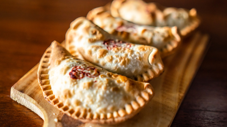 Baked empanadas on a board