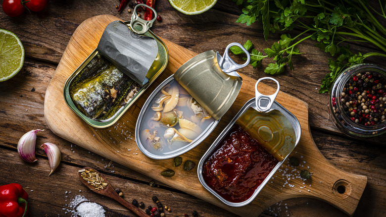 Canned fish on wooden board
