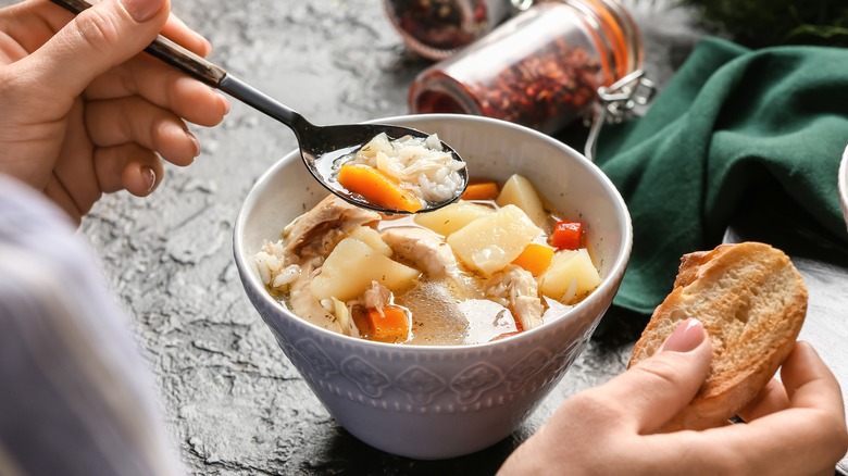 woman eating soup