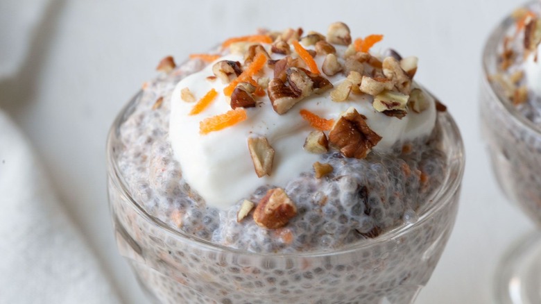 Carrot cake chia pudding topped with yogurt, shredded carrot, and pecans
