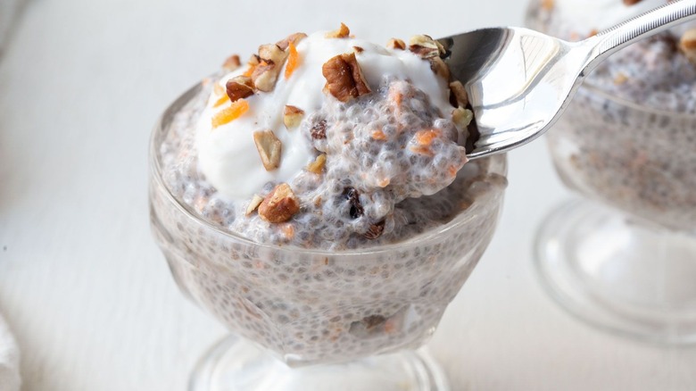 Spoon removing bite of carrot cake chia pudding from bowl