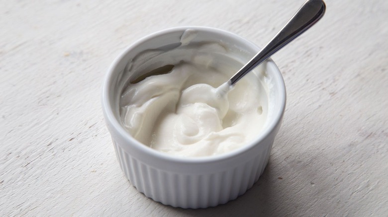 Greek yogurt in small bowl with spoon