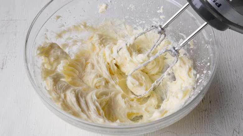 beating cream cheese, butter, and sugar in bowl