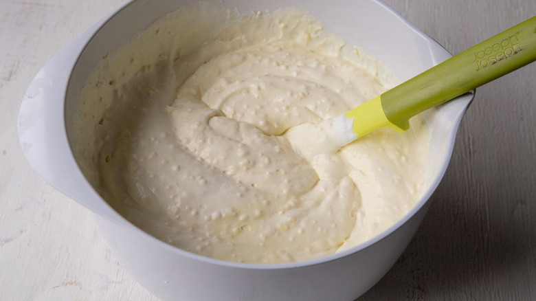 mixing whipped topping with pudding in bowl