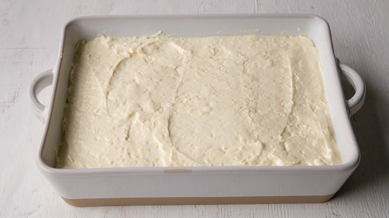 creamy mixture spread in baking dish