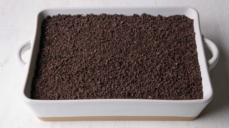 ground oreos spread in baking dish