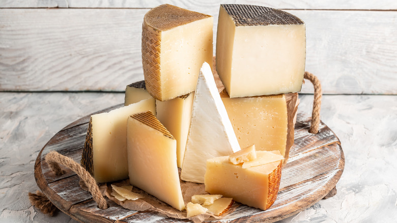 Cheeses stacked on wooden wheel