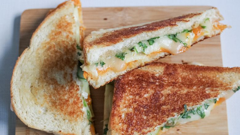 grilled cheese slices on cutting board