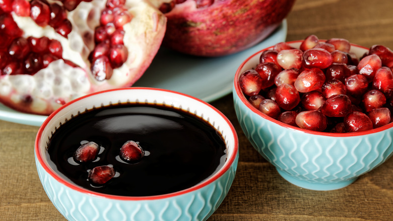 pomegranate seeds floating in pomegranate molasses