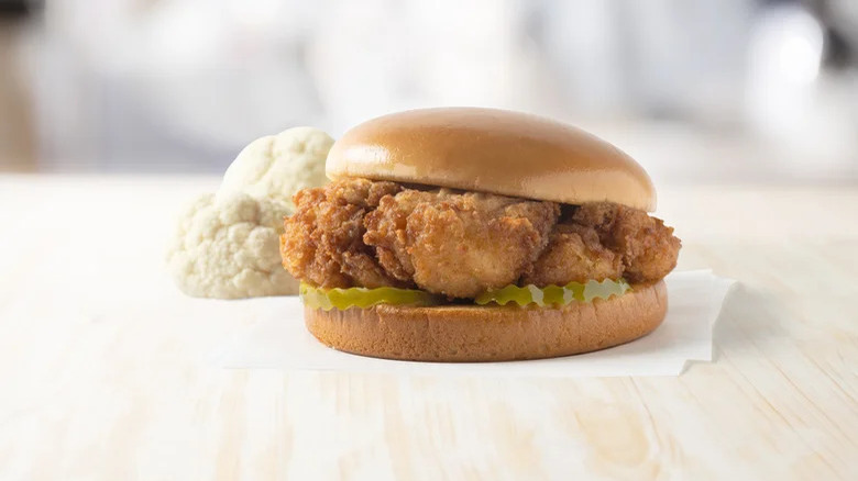 chick-fil-a sandwich next to a piece of raw cauliflower