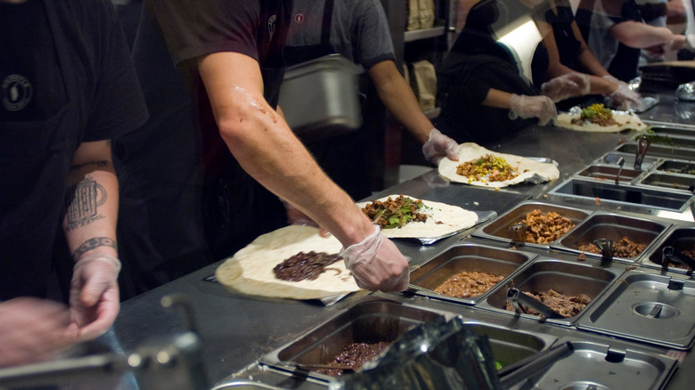 Chipotle employees making burritos