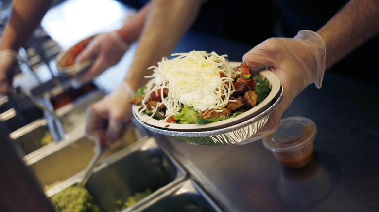 preparing a chipotle bowl