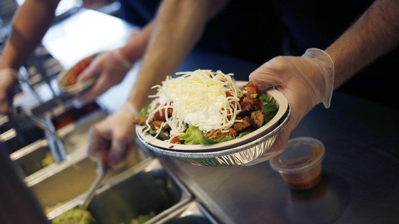 Chipotle employee making food