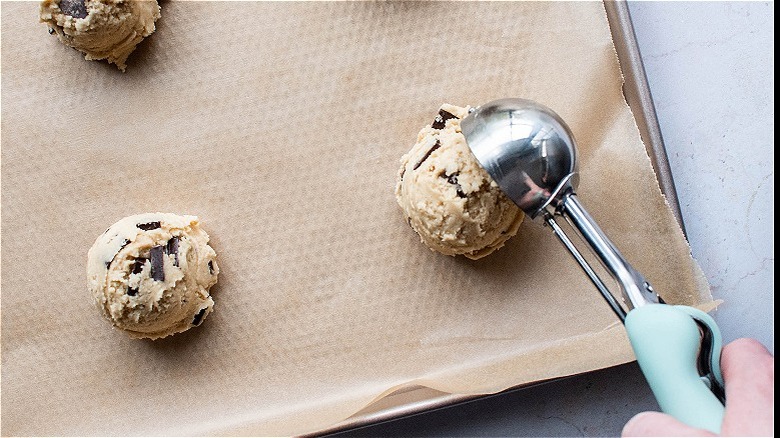 scooping dough onto sheet tray