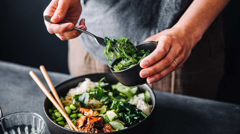 Person eating seaweed salad