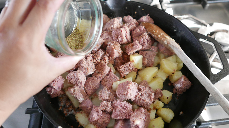 corned beef hash ingredients in skillet 
