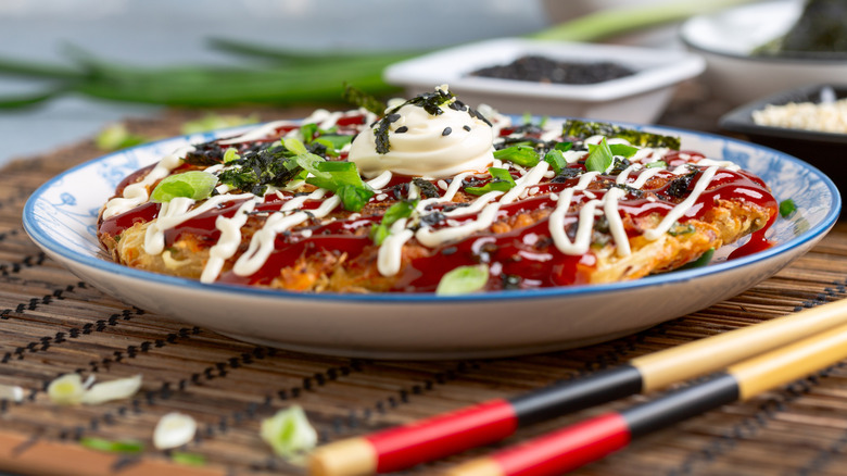 Side view of okonomiyaki pancake served on plate