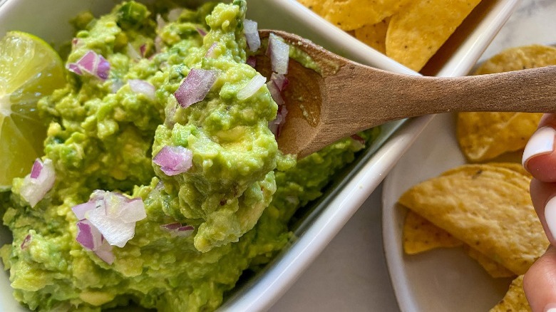 guacamole on spoon with tortilla chips