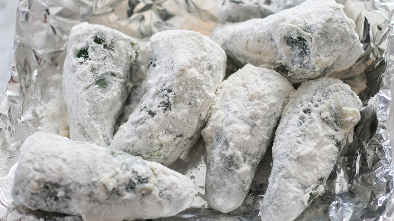 floured jalapeño peppers on foil