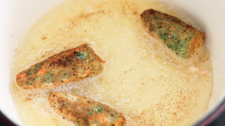 jalapeño poppers frying in oil