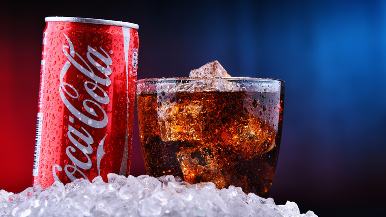 Coca Cola can and glass on ice