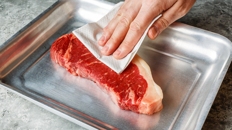 Patting down the steak