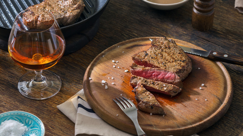 Glass of whiskey and steak