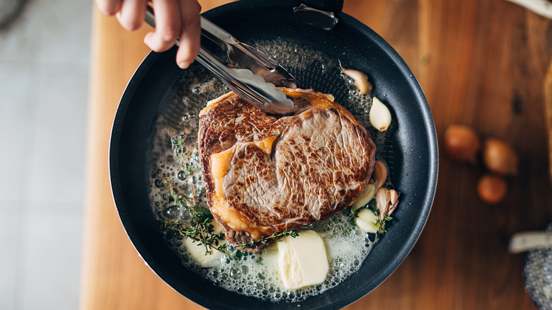 Cooking a ribeye with butter and thyme