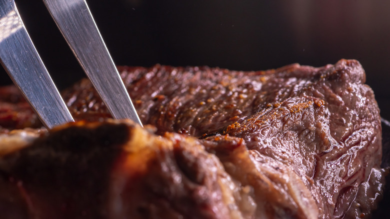 Stabbing a steak with a fork