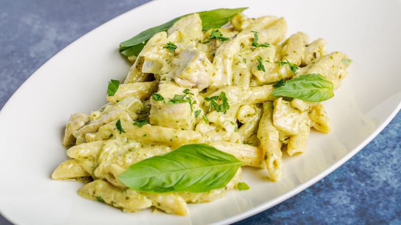 Pasta with pesto Alfredo on white dish